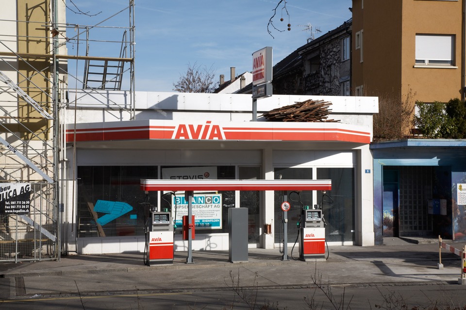 Before: Front entrance of the gallery, then former showroom of the garage and gas station in front