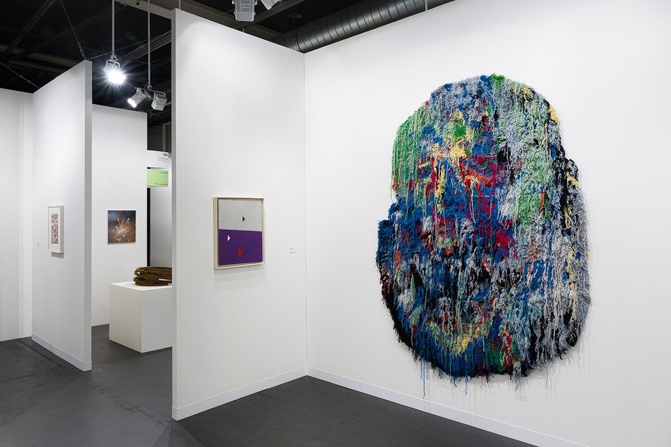 Installation view of Art Basel 2024\
with works by (f.l.t.r.) Sophie Taeuber-Arp, Francisco Sierra, Bernar Venet, Friedrich Vordemberge-Gildewart and Caroline Achaintre